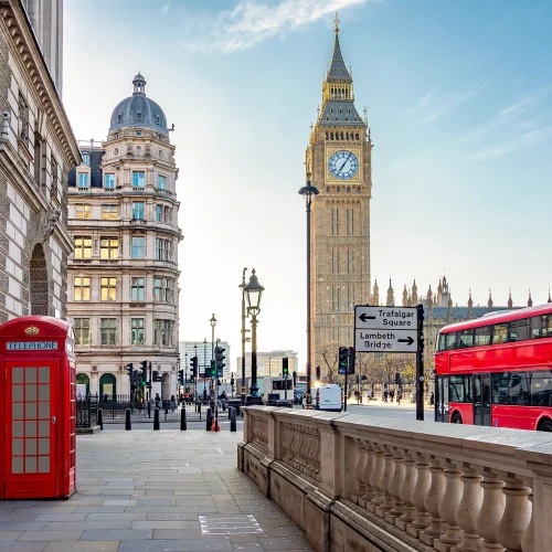 Big Ben and red double-decker buses on a London street