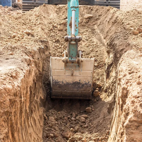 Excavator digging a trench during archaeological excavation