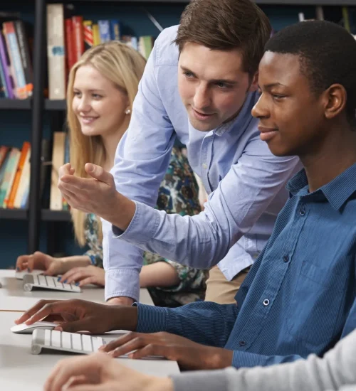 stock-photo-tutor-working-with-group-of-teenage-students-using-computers-341409872-1920w